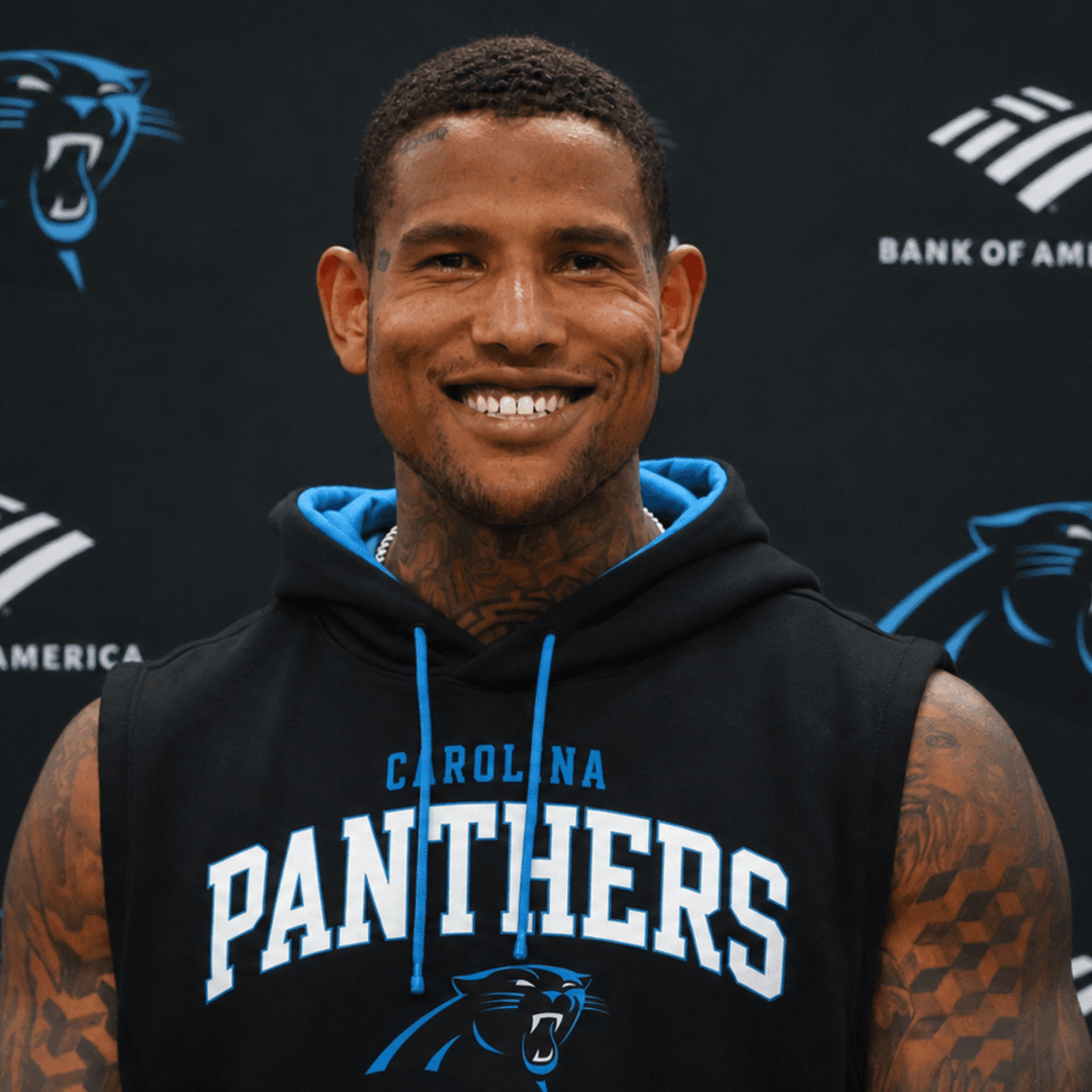 Darren Waller in Carolina Panthers apparel at a team media backdrop