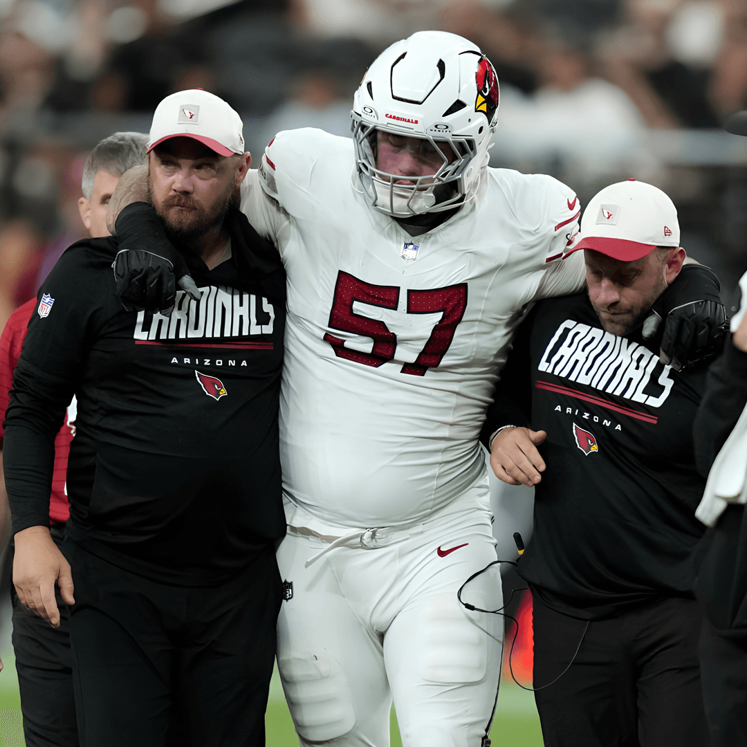 Arizona Cardinals guard Chase Bisontis being helped off the field after a knee injury