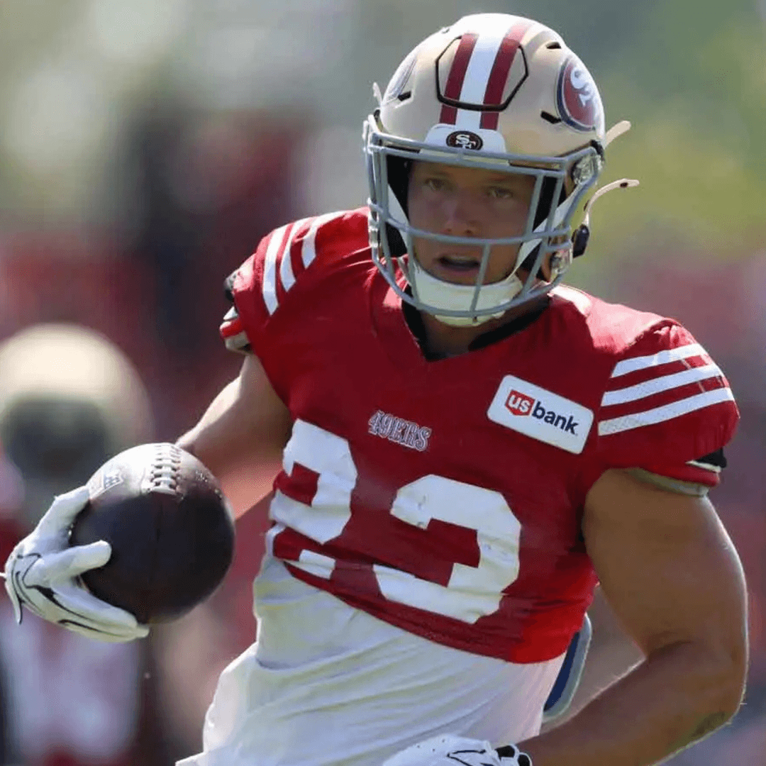 Christian McCaffrey carrying the football at San Francisco 49ers practice