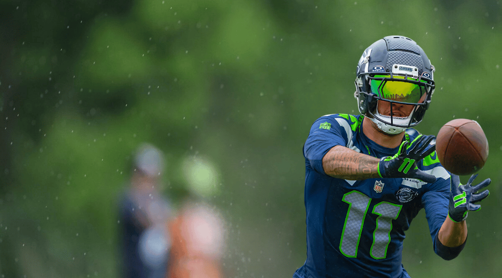 NFC West Camp Watch hero image featuring Jaxon Smith-Njigba in Seattle Seahawks training camp.